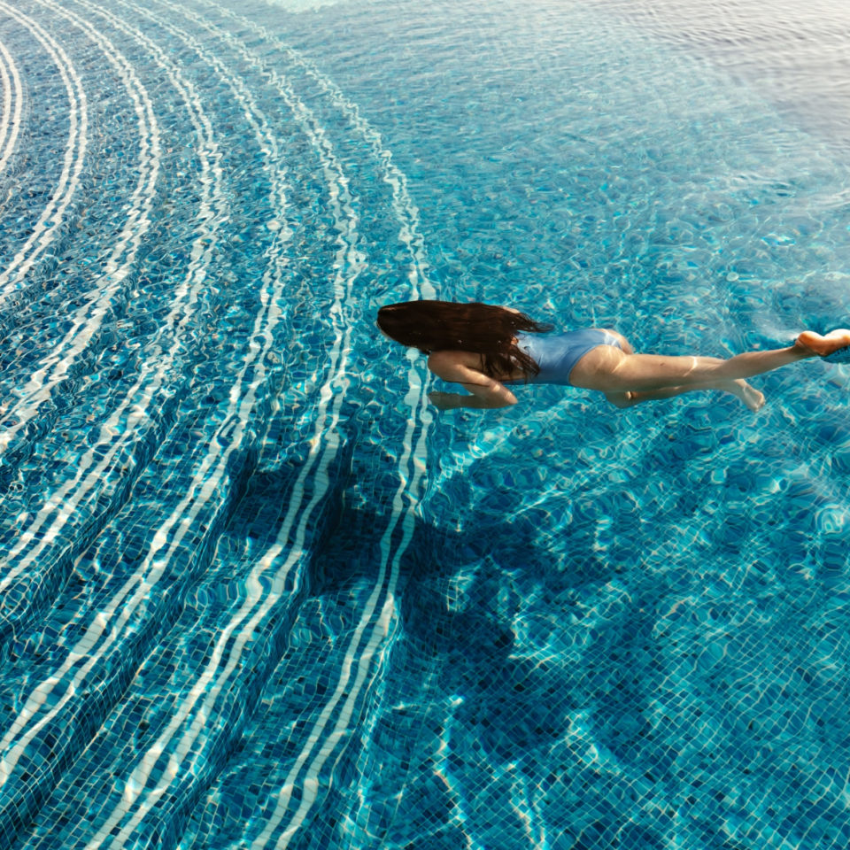 Woman Swimming in the Infinity Beach Club